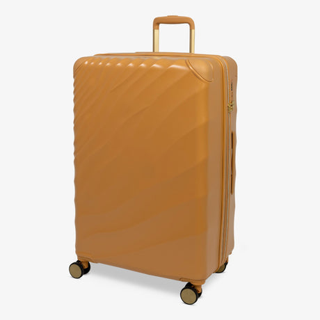 Gold Sunset Sahara large suitcase, angled view showing the wave-design shell