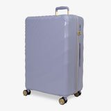 Lilac Sunrise Sahara large suitcase, angled view showing the wave-design shell