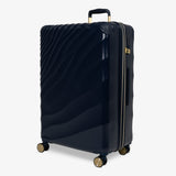 Midnight Navy Sahara large suitcase, angled view showing the wave-design shell
