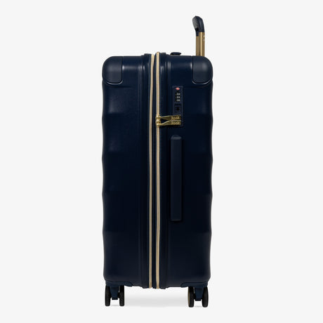 Midnight Navy Sahara medium suitcase, side view showing the side handle and reinforced corners