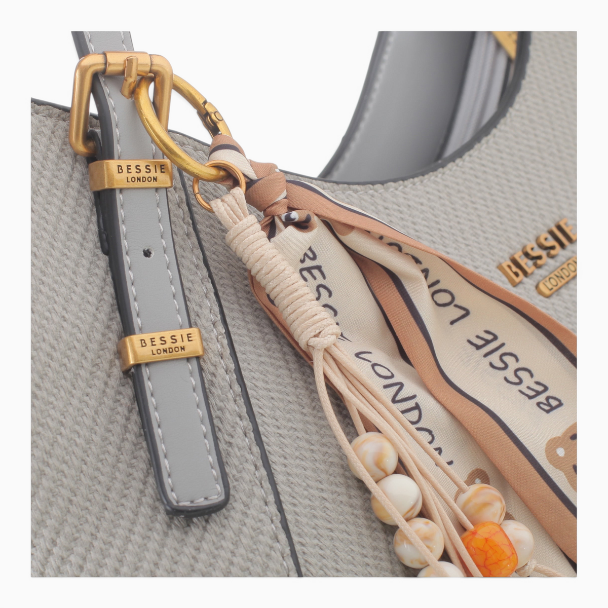 Bag Shack BESSIE LONDON textured grey hobo bag with gold hardware, decorative scarf charm, and beaded accents.