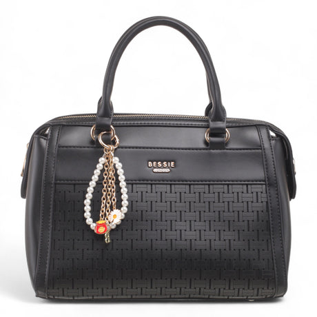 Bag Shack Bessie black faux leather handbag with woven front panel, gold hardware, and decorative pearl charm.