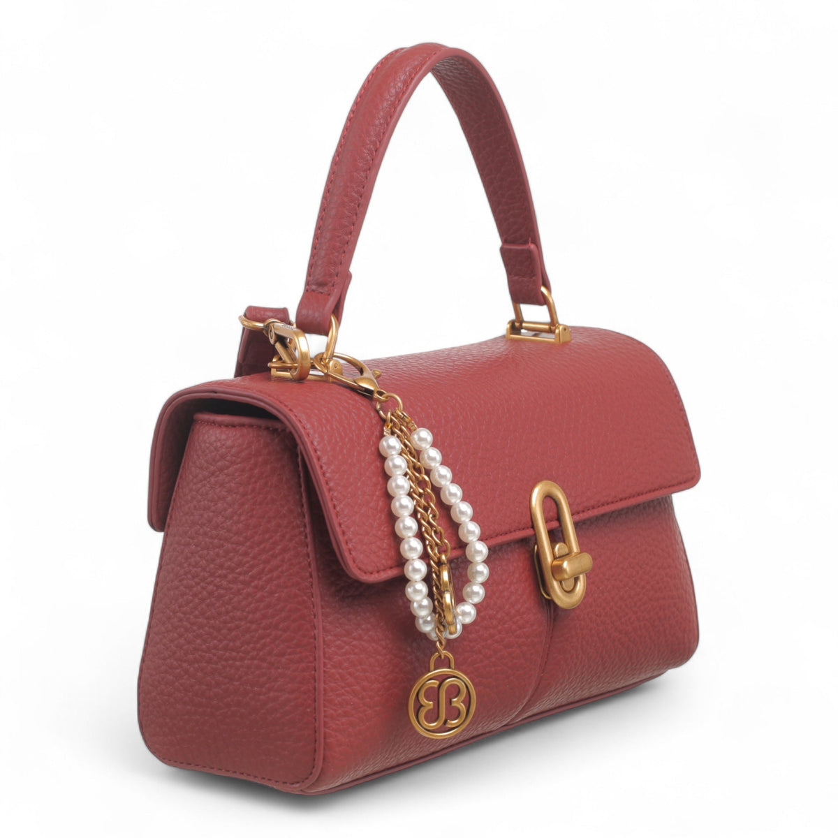 Bag Shack burgundy faux leather compact handbag with gold lock detail, top handle, and decorative pearl chain charm.