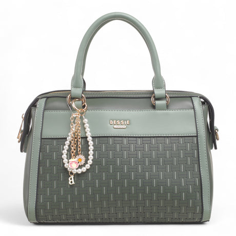Bag Shack Bessie green faux leather handbag with woven front panel, gold hardware, and decorative pearl charm.