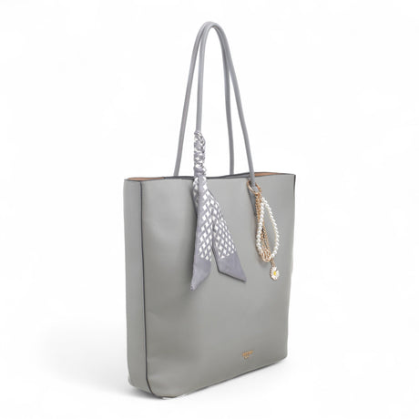 Bag Shack Bessie grey faux leather tote bag with a decorative scarf and pearl charm, side view