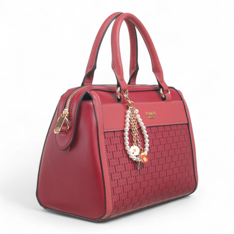 Bag Shack wine red faux leather handbag with woven front panel, gold hardware, and decorative pearl charm.